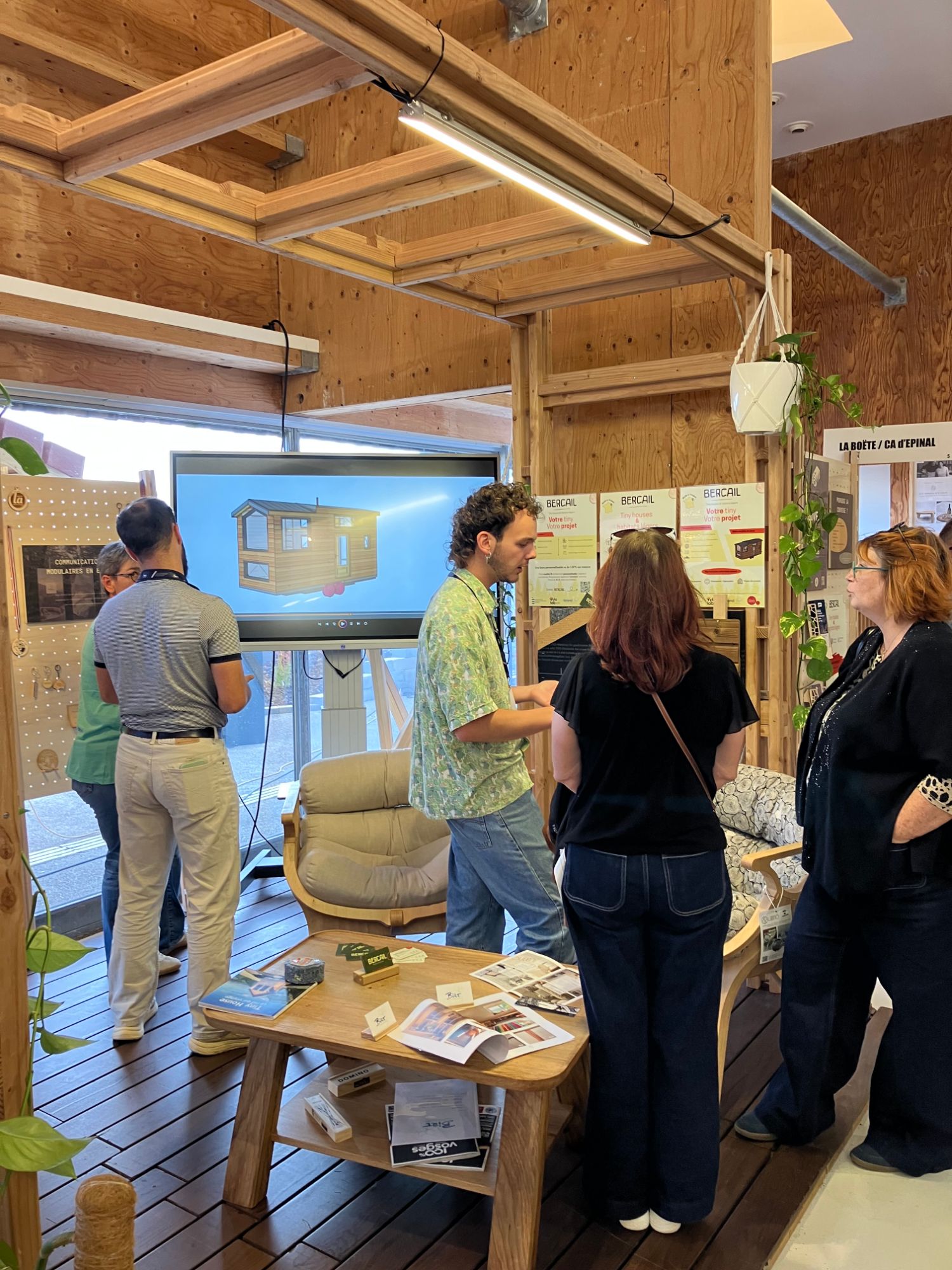 Présentation d'une tiny house en 3D à des visiteurs sur le stand Atelier Bercail
